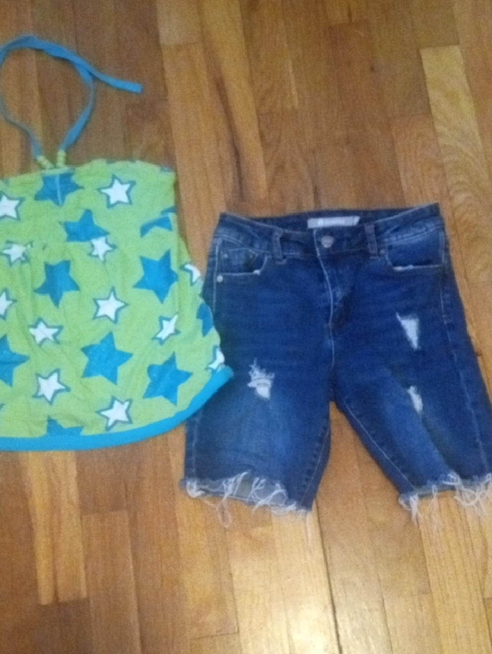 girl 10 distressed denim shorts and bright halter tank